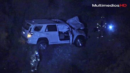 A wrecked white SUV is shown at the bottom of an embankment of Shinn Road in the Angeles National Forest on Tuesday, Sept. 24, 2013.
