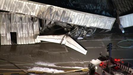 The tail of a small plane that crashed at Santa Monica Airport on Sunday, Sept. 29, 2013, is seen.