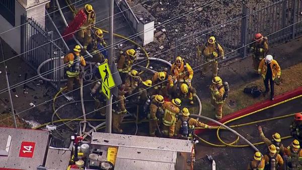 A firefighter is rescued from a burning church in Los Angeles on Tuesday, Oct. 8, 2013.