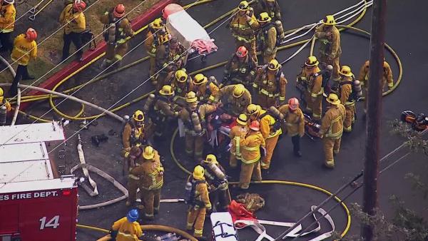 A firefighter is rescued from a burning church in Los Angeles on Tuesday, Oct. 8, 2013.