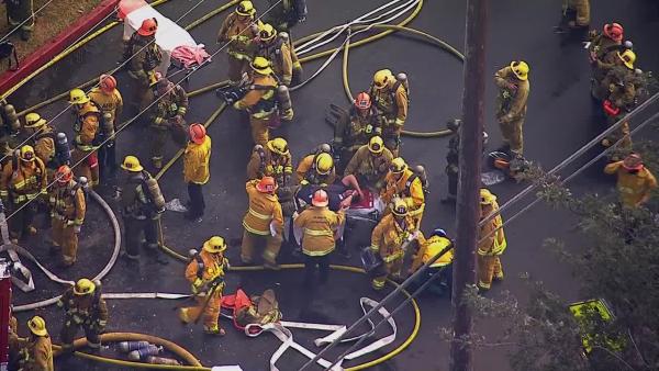 A firefighter is rescued from a burning church in Los Angeles on Tuesday, Oct. 8, 2013.