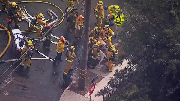 A firefighter is rescued from a burning church in Los Angeles on Tuesday, Oct. 8, 2013.