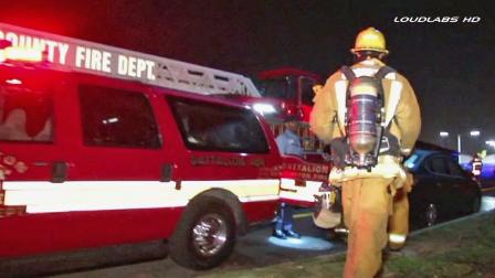 Firefighters gather at the scene of a fire in the 600 block of South Bullis Road in Compton on Saturday, Oct. 12, 2013.