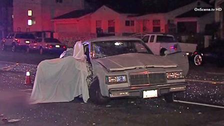 Authorities respond to the scene of a fatal crash near 120th Street and Budlong Avenue in the Athens area of Los Angeles Saturday, Oct. 12, 2013.