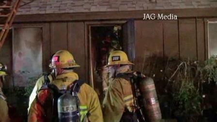 Firefighters at the scene of a house fire in Sylmar on Sunday, Oct. 20, 2013.