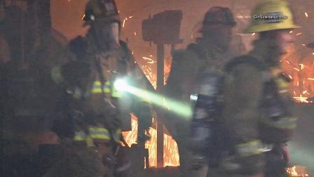 Firefighters battle a fire at a storage building and workshop on the 11000 block of Art Street in Sun Valley on Sunday, Nov. 3, 2013.