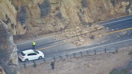 Large boulders block lanes of Malibu Canyon Road at Las Virgenes Road following a rockslide Monday, Nov. 11, 2013.