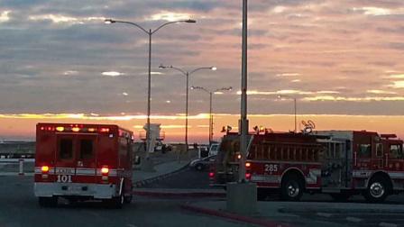 Los Angeles City Fire Department officials respond to the area near the Cabrillo Beach breakwater in San Pedro after a man died trying to save two people who were swept by a large wave Saturday, Nov. 30, 2013.