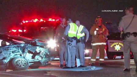 Authorities investigate the scene of a car crash on the 60 Freeway in Montebello that left one woman dead on Sunday, Dec. 15, 2013.