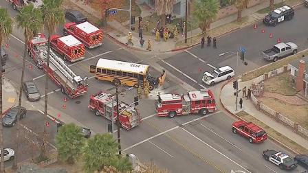 Emergency vehicles are shown at the scene of a crash between a school bus and a passenger vehicle in the 7000 block of Corbin Avenue in Reseda on Thursday, Dec. 19, 2013.