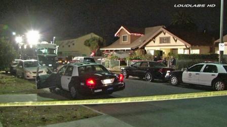 Police patrol vehicles are shown behind crime tape at the scene of an officer-involved shooting in the 1300 block of West 50th Street in South Los Angeles on Friday, Dec. 27, 2013.