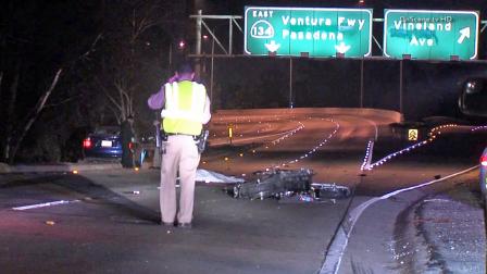 A law enforcement official investigates the scene of a fatal crash on the eastbound 101 Freeway transition to the eastbound 134 Freeway on Saturday, Jan. 11, 2014.