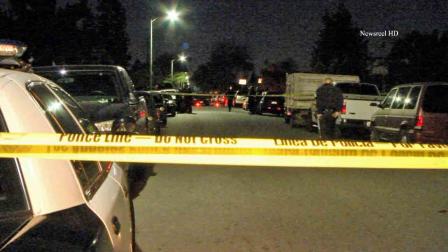 Police respond to the scene of a fatal shooting on the East 76th Place in South Los Angeles Monday, Jan. 13, 2014.