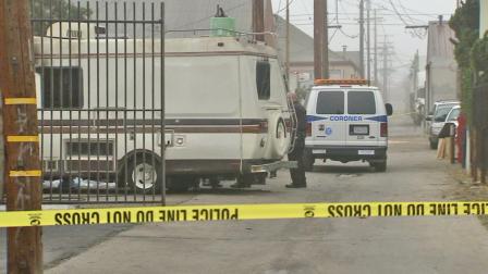 Crime tape ropes off the scene of a motor home fire in Long Beach, where an adult body was found on Tuesday, Jan. 28, 2014.