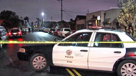 A police patrol vehicle is shown behind crime tape near the scene of a shooting in the 5300 block of Budlong Avenue in South Los Angeles on Friday, Feb. 7, 2014.