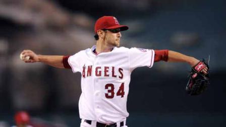 Los Angeles Angels starting pitcher Nick Adenhart throws to first during the first inning of their Major League Baseball game against the Oakland Athletics, Wednesday, April 8, 2009, in Anaheim, Calif.