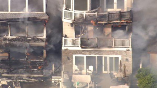 A four-alarm fire damaged three beachfront homes in Sunset Beach, one of which collapsed, on Thursday, May 12, 2011.