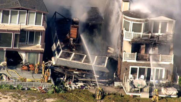 A four-alarm fire destroyed one beachfront home and damaged two others in the Sunset Beach on Thursday, May 12, 2011.