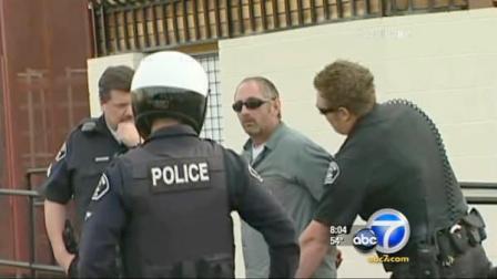 Officers apprehend a man suspected of robbing an Opus Bank branch on West Orangethorpe Avenue in Fullerton on Friday, March 23, 2012.