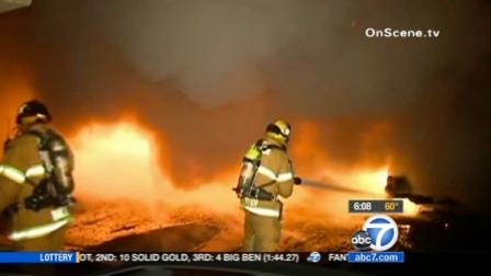 Firefighters battle a blaze at a carport in Anaheim on Monday, June 4, 2012.