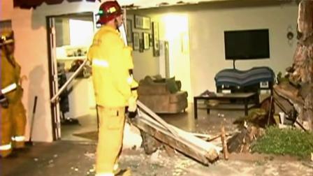 Firefighters look through the wreckage from a car crash at an apartment complex in Fullerton on Friday, June 22, 2012.