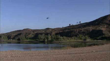 A helicopter flies over Irvine Lake, where two men went missing after their inflatable boat capsized on Sunday, June 24, 2012.