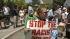 A protester holds up a sign during a...