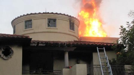 Flames and smoke shoot out of a house on the 31000 block of Via Consuelo in Coto De Caza on Saturday, Sept. 29, 2012.