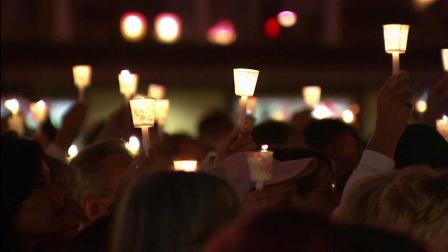 Many gathered on Thursday, Oct. 11, 2012, for a vigil to remember the first anniversary of a deadly salon shooting in Seal Beach.
