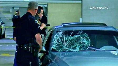 Law enforcement officials inspect a broken windshield in Anaheim on Wednesday, Nov. 21, 2012.