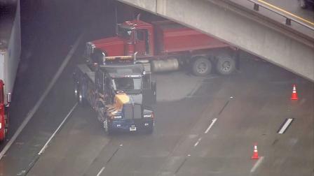 A tow truck is seen after it jackknifed and spilled gravel across lanes on the 91 Freeway in Anaheim on Monday, Dec. 3, 2012.