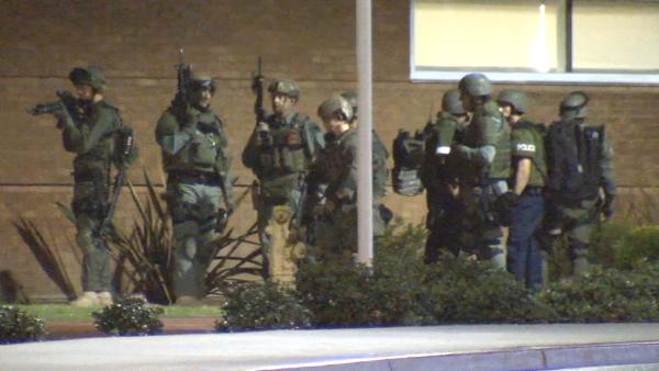 Authorities move in on a building on the California State University, Fullerton, campus where they believed a possibly armed suspect may have been hiding out on Wednesday, Dec. 12, 2012.