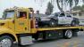 A Fullerton police vehicle is towed away following a shooting near Woods and Knepp avenues on Sunday, March 17, 2013.