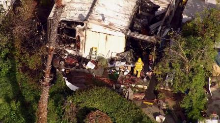 Authorities search a mobile home destroyed by a fire in La Habra on Monday, April 1, 2013.