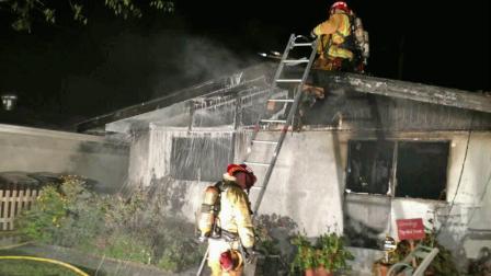 Firefighters battle a house fire near Stanton in Orange County in this April 2013 photo.