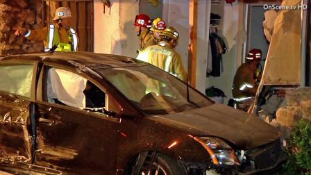 Emergency officials assess the damage done to a Garden Grove apartment complex after a car slammed into the building on Saturday, April 27, 2013.