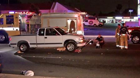 Investigators inspect a white truck that struck a homeless man in Anaheim on Katella Avenue just west of Euclid Avenue on Thursday, May 16, 2913.