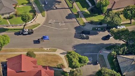 Police set up a perimeter around the covered body of a female bicyclist who was struck and killed by a FedEx truck in Fullerton Thursday, June 20, 2013.