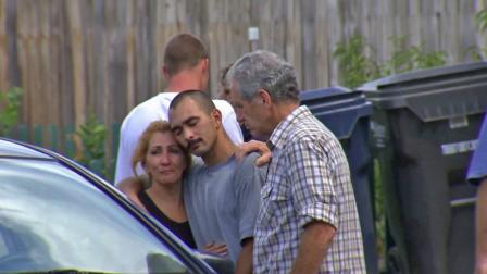 Onlookers mourn following a fatal officer-involved shooting at Glencoe Drive and Silver Lane in Huntington Beach, Calif., on Saturday, Aug. 3, 2013.