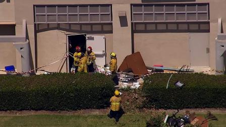 Authorities investigate after a car slammed into a business in Fountain Valley on Monday, Aug. 19, 2013.