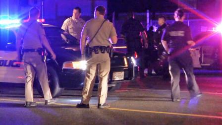 Law enforcement officials gather near the intersection of Stanton and Orangethorpe avenues in Buena Park on Saturday, Oct. 5, 2013. A Buena Park police officer in a marked cruiser crashed into a female pedestrian, killing her.