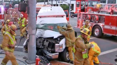 Crews are seen after an ambulance crashed into a pole outside Childrens Hospital of Orange County on Sunday, Oct. 13, 2013. Two people inside were rescued and had minor injuries.