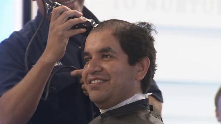 A firefighter gets his head shaved to show support for young patients at Childrens Hospital of Orange County on Tuesday, Oct. 23, 2013.