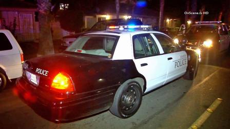 Two police cruisers are parked near the scene of a stabbing in the 1600 block of 9th Street in Anaheim on Sunday, Oct. 27, 2013.