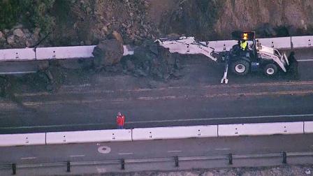 Crews attempt to move debris from a rockslide along the Pacific Coast Highway in the Dana Point area on Friday, Jan. 10, 2014.