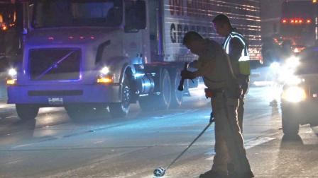 Law enforcement officials investigate the scene of a fatal car crash on the 57 Freeway in Fullerton on Wednesday, Jan. 29, 2014.