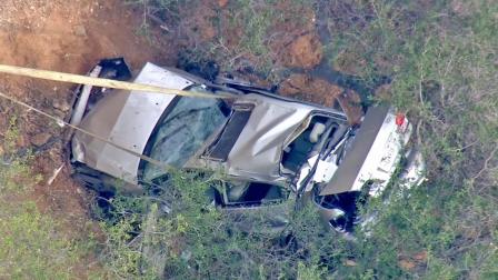 A wrecked car is shown at the bottom of a dry river bed after a motorist drove off the 241 toll road in Irvine on Wednesday, Feb. 26, 2014.