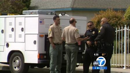 Authorities are seen outside the Oxnard home where a 2-year-old boy was bitten in the face by a pit bull on March 25, 2012.