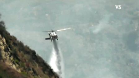 A helicopter makes a water drop over a fire in Los Padres National Forest on Sunday, Aug. 5, 2012.