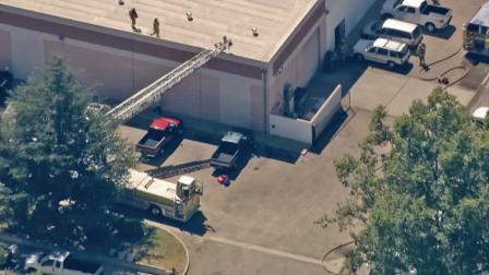 Fire crews are seen atop a commercial building in Simi Valley where a fire was knocked down on Tuesday, August 28, 2012. At least one person was reportedly burned.